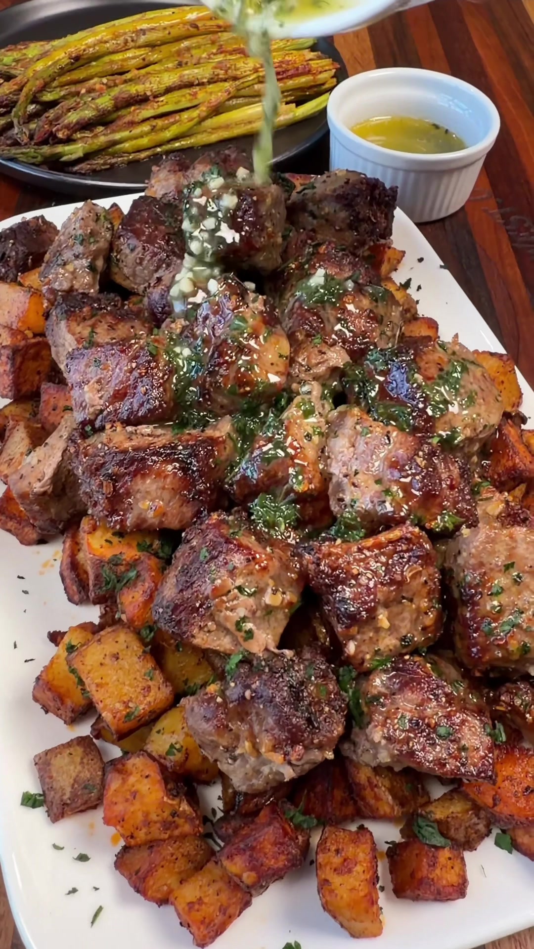 Air fryer Garlic Butter Steak Bites & Potatoes🤤 INGREDIENTS   3 large potatoes olive oil + salt, pepper, garlic powder, paprika, (for potatoes) 2 New York Strip steaks Olive Oil Montreal Steak Seasoning  4 tbsp of butter  1 tbsp of minced garlic  1 tsp dried parsley  INSTRUCTIONS  Wash the potatoes and cut them up into small cubes. Toss with olive oil, salt, pepper, garlic powder, and paprika (I don’t use exact measurements for this part). Cook the potatoes in the air fryer at 400 F degrees for about 20-25 minutes shaking them around at least a couple times while they cook.  Once the potatoes are cooking, cut the steak into cubes. In a large bowl coat steak in olive oil and some steak seasoning.  Once your potatoes are crispy, remove them from the air fryer and add the steak. Cook the steak to your liking. Mine cooked for about 7 minutes for medium to medium well steak like my family likes it.  Mix together melted butter, minced garlic, and dried parsley. Add the crispy potatoes to a plate. Top with the garlic butter steak bites the garlic butter. Enjoy!  #easyrecipes #dinner #steak 