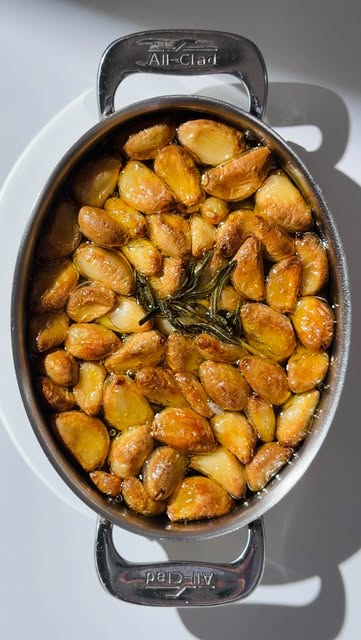 Garlic Confit 🧄

Ingredients 
⤵︎
2 cups peeled garlic cloves (about 4–5 heads)
1 1/2-2 cups extra virgin olive oil (enough to fully submerge)
1 pinch salt

Optional
1 rosemary sprig
3–4 sprigs fresh thyme
1/2 tsp whole black peppercorns 

⸻
Instructions
Prep → Add garlic cloves to a small saucepan or oven-safe dish. Pour in olive oil until garlic is fully submerged.

Flavor (optional) → Add rosemary, thyme, and peppercorns for a subtle aromatic layer.

Bake → At 250°F (120°C) for 45–60 minutes
until garlic is soft and lightly golden.

Cool → Remove from heat and let cool completely in the oil.

⸻
Storage
• Transfer to a clean jar, keep garlic fully submerged in oil
• Refrigerate up to 2 weeks
• Always use a clean spoon

⸻
#garlicconfit 
#chef 
#cookingtips 
#easyrecipes 
#oliveoil
