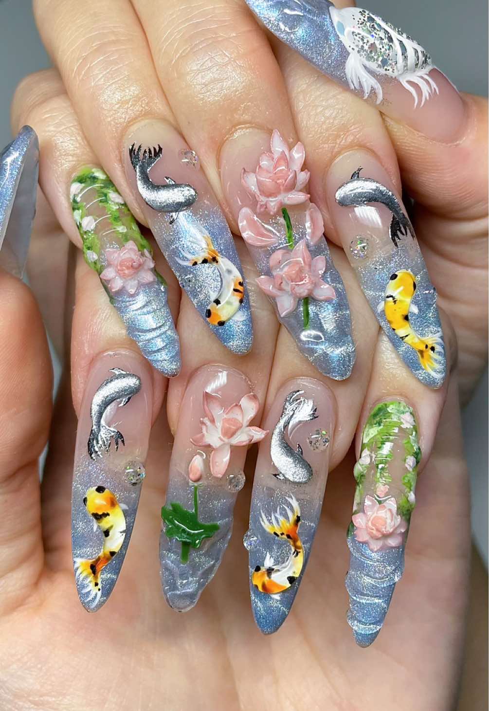 Do koi pond nails with me 🐟🪷 Inspired by the talented @Ames 🥹 Products used: @Sweetie Nail Supply (code: CXHNAILS) ✨DVOK clean girl collection DS22 ✨Jin.b crazy top thick @BeetlesGelPolish (code: CXHNAILS10) ✨shimmer blue cateye f289  @gaoy_official  ✨1120, 1575, 1583, 1591 @MakarttOfficial  ✨solid nail glue gel @yhh_nail  ✨pat gel palette Other: ✨principal flower non-wipe black gel ✨supwee silver glitter cateye #springnails #3dnailart #nailinspo #domynailswithme #asmr 