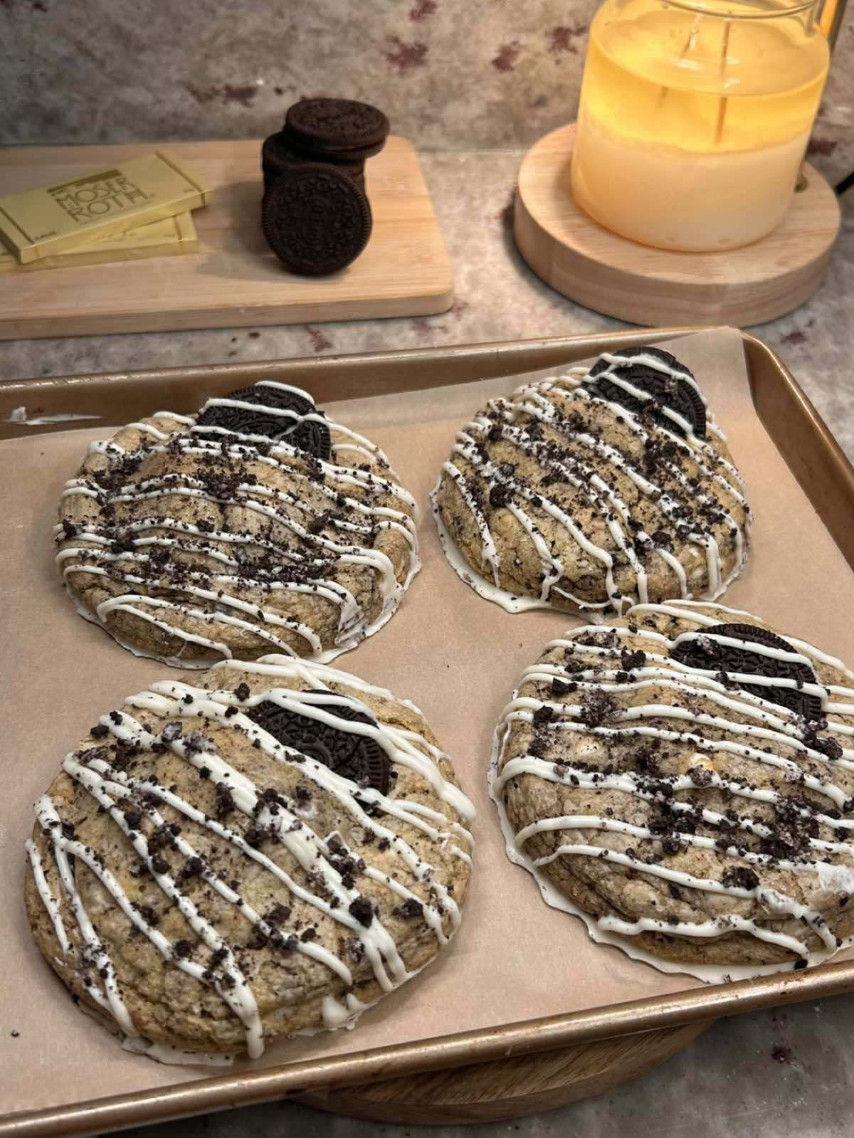 bakery style oreo stuffed cookies 🍪🥛    recipe: ingredients: ¾ cup salted butter, softened (170 g) ¾ cup packed brown sugar (150 g) ¼ cup granulated sugar (50 g) 1 large egg  1 tsp vanilla (5 g) 2 cups all-purpose flour (240 g) 1 tbsp cornstarch (8 g) ½ tsp baking soda (3 g) ¼ tsp salt (1.5 g) oreos, some whole some  roughly chopped  white chocolate (measure with your heart)  & choceur cookie and cream chocolate’s   instructions: cream the butter and sugars together  until smooth and slightly fluffy. mix in the egg and vanilla until fully combined. in a separate bowl, whisk together the flour, cornstarch, baking soda, and salt. fold the dry ingredients into the wet just until combined.  chop some of the oreos into small chunks ( leave some for topping ) and fold them in along with the white chocolate. scoop the dough into 8 portions, flatten and add an oreo inside and chocolate then shape into tall mounds. ( i flatten the top but keep them tall ) bake at 375°F for 11–14 minutes, until the edges are set and the centers are still soft. ( baking time may vary ) let cool to set the cookies!  i added moser roths white chocolate to the bottom & inside !    #oreo #cookies #chocolatechipcookies #Recipe #baking 